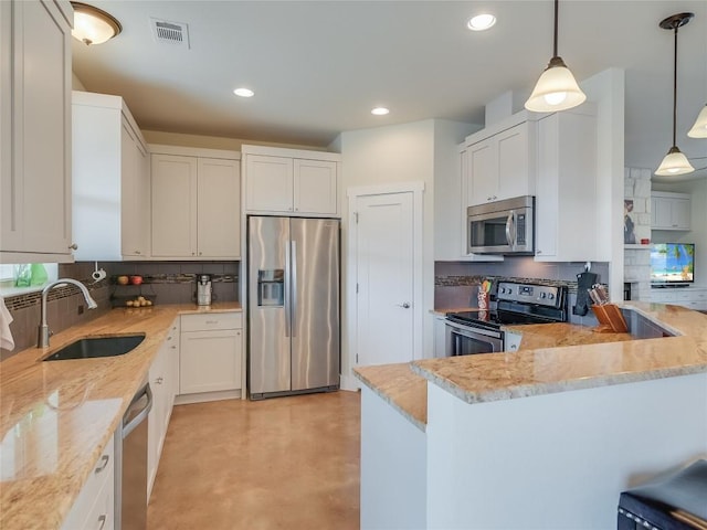 kitchen featuring visible vents, a sink, light stone counters, backsplash, and appliances with stainless steel finishes