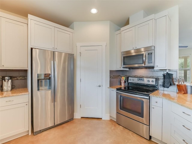 kitchen featuring light stone counters, stainless steel appliances, recessed lighting, and decorative backsplash