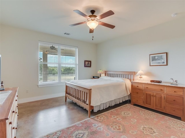 bedroom featuring visible vents, ceiling fan, concrete floors, and baseboards