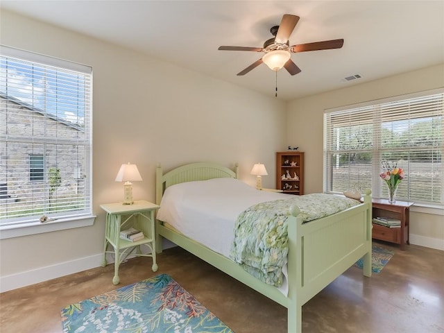 bedroom featuring visible vents, multiple windows, a ceiling fan, and baseboards