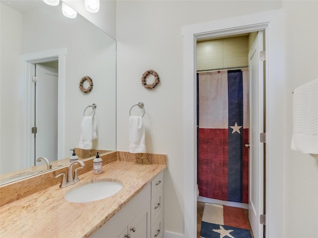 bathroom featuring curtained shower and vanity