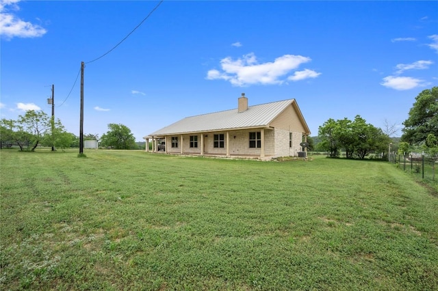 551 Gatlin Creek Rd, Dripping Springs, TX 78620 - rear view of property featuring a chimney and metal roof