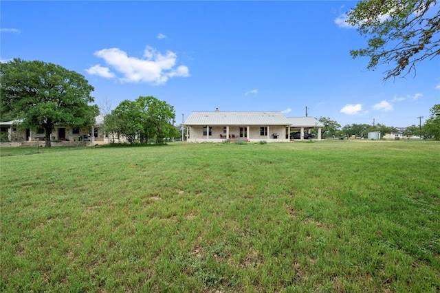 551 Gatlin Creek Rd, Dripping Springs, TX 78620 - rear view of property featuring a lawn and metal roof