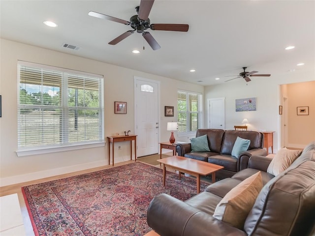 living area with visible vents, wood finished floors, recessed lighting, baseboards, and ceiling fan