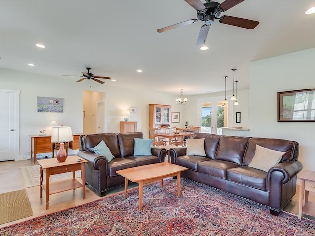 living area with ceiling fan with notable chandelier, recessed lighting, and french doors