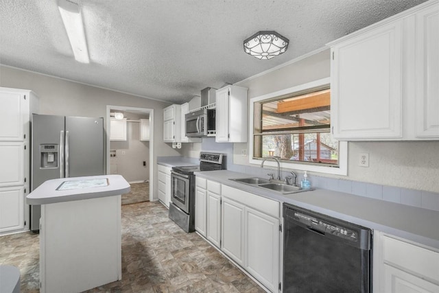 kitchen featuring a sink, light countertops, appliances with stainless steel finishes, white cabinetry, and a center island