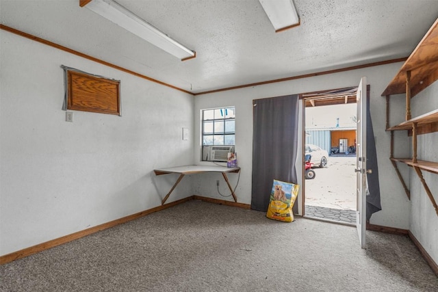 empty room with cooling unit, carpet floors, a textured ceiling, and baseboards