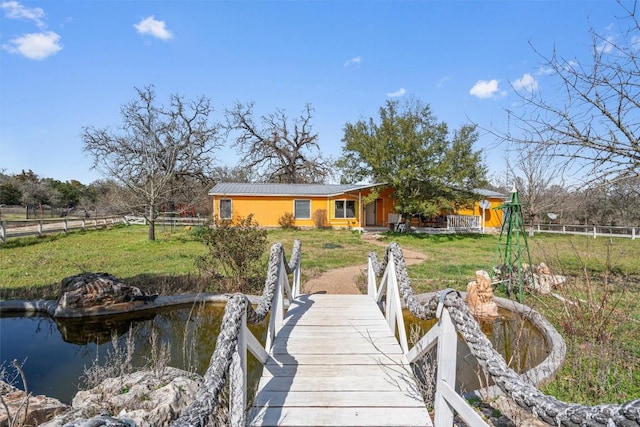 view of dock featuring fence and a lawn