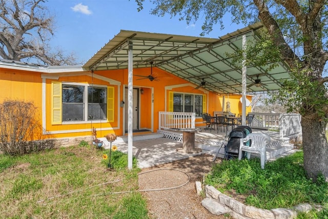 172 Hershal Ln, Cedar Creek, TX 78612 - rear view of house featuring a ceiling fan and outdoor dining area