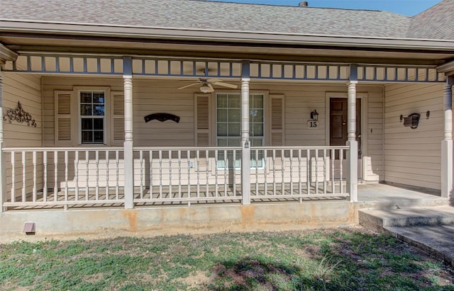 doorway to property with roof with shingles, a porch, and a ceiling fan