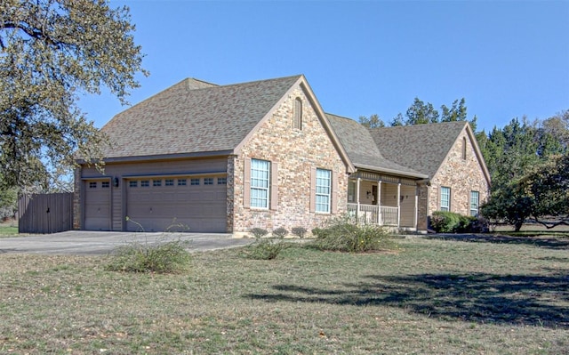 view of front of property with brick siding, a porch, concrete driveway, and a garage