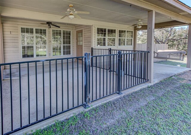 exterior space with ceiling fan and fence