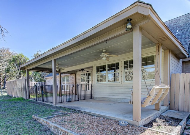 view of patio with fence and ceiling fan