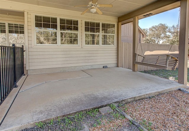 view of patio / terrace featuring ceiling fan and fence