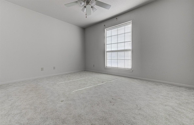 spare room featuring carpet floors, a textured ceiling, and ceiling fan