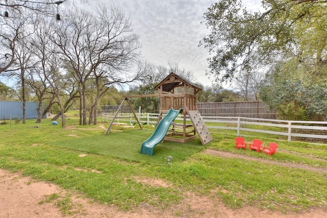 view of play area featuring a lawn and fence