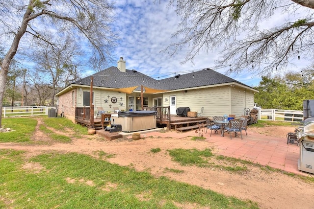 back of property featuring a hot tub, central AC unit, a deck, and fence