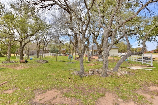 view of yard with a playground and fence