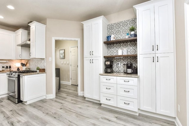 kitchen featuring open shelves, light wood-style flooring, stainless steel range with gas stovetop, and white cabinets