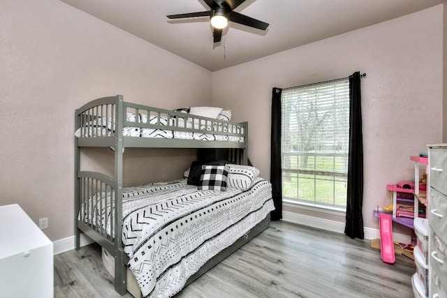 bedroom featuring wood finished floors and baseboards