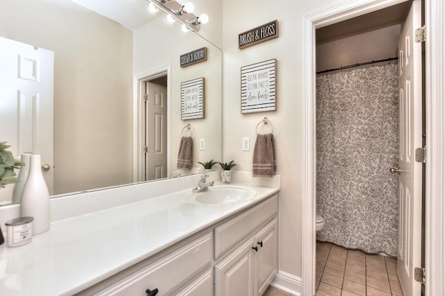 bathroom with tile patterned floors, toilet, and vanity