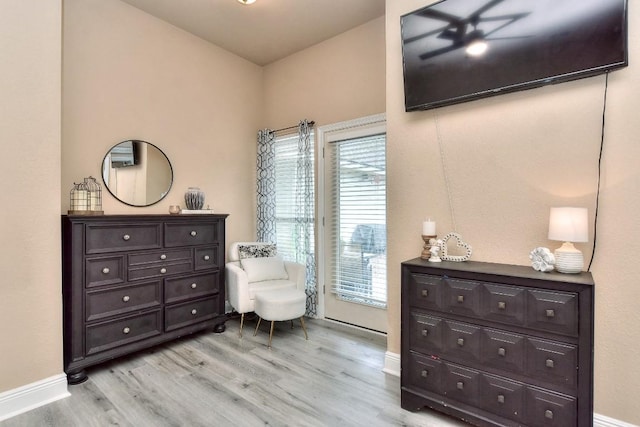 sitting room featuring baseboards and light wood-style floors