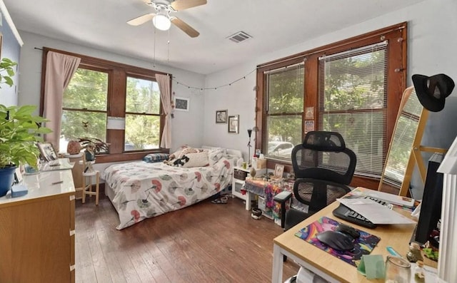 bedroom featuring visible vents, ceiling fan, and wood-type flooring