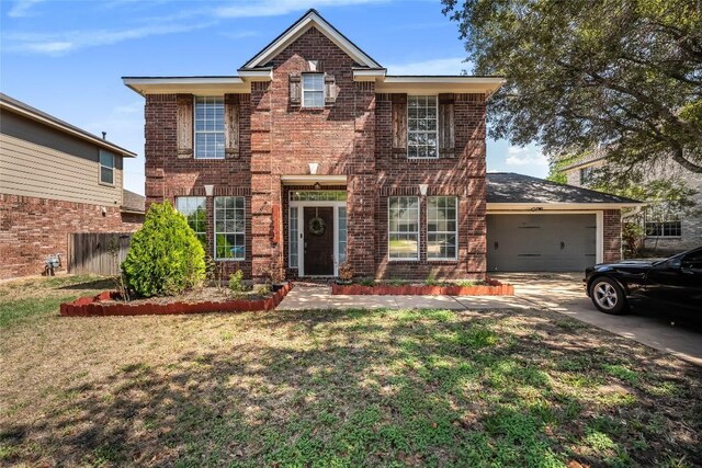 16901 W Stockton Dr, Leander, TX 78641 - traditional-style home with brick siding, an attached garage, and driveway
