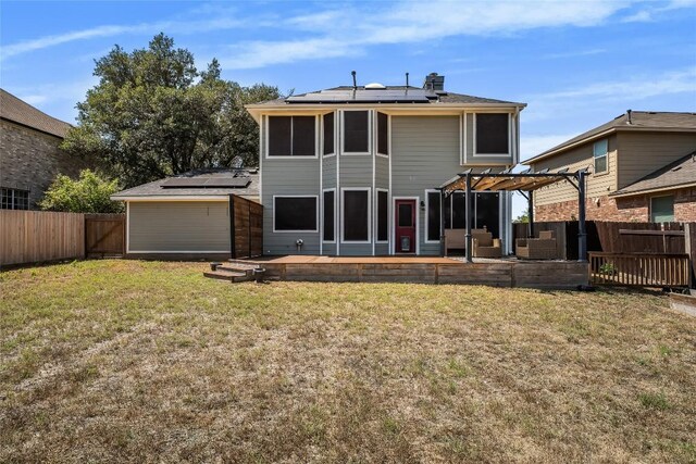 16901 W Stockton Dr, Leander, TX 78641 - rear view of property featuring roof mounted solar panels, a pergola, a fenced backyard, and a deck