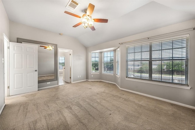 unfurnished bedroom featuring visible vents, baseboards, carpet, and vaulted ceiling