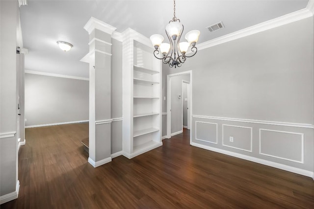 unfurnished dining area with visible vents, built in shelves, wood finished floors, and crown molding