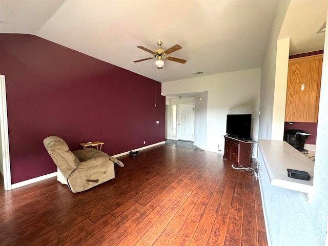 unfurnished room featuring wood finished floors, baseboards, visible vents, ceiling fan, and vaulted ceiling