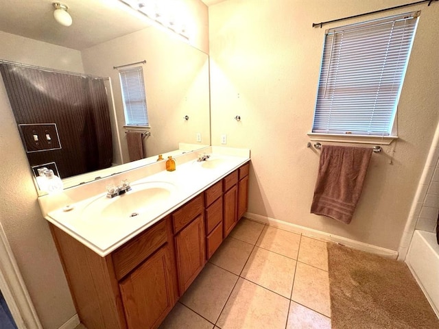 bathroom featuring a sink, walk in shower, double vanity, and tile patterned floors