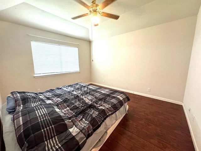 bedroom featuring a ceiling fan, wood finished floors, and baseboards