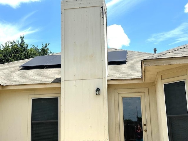 exterior details featuring a shingled roof