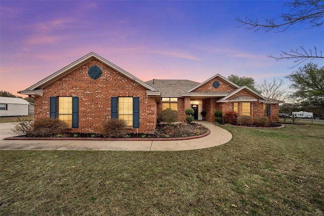 single story home featuring brick siding and a front lawn