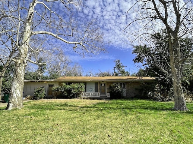 ranch-style home featuring a porch, a front yard, and board and batten siding