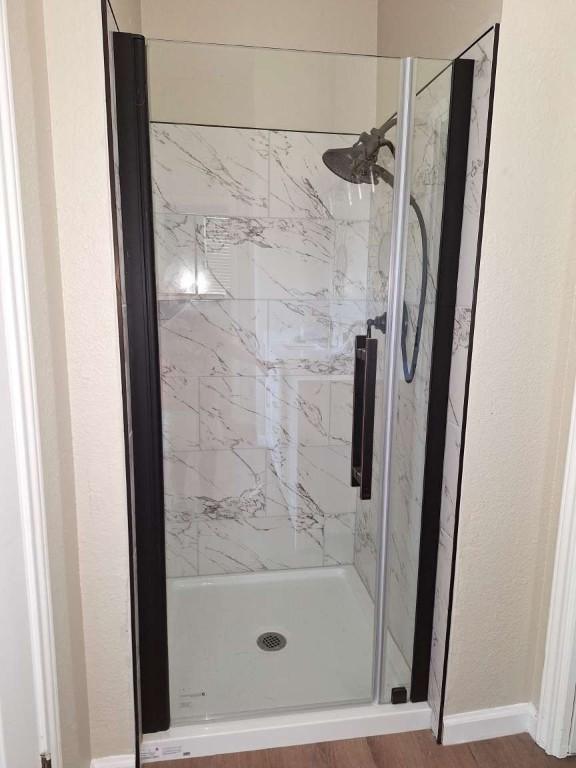 107 Patricia Rd, Georgetown, TX 78628 - full bath featuring a marble finish shower and a textured wall