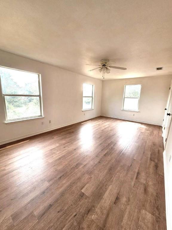 107 Patricia Rd, Georgetown, TX 78628 - unfurnished room featuring a ceiling fan and wood finished floors
