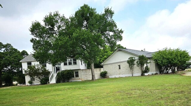 107 Patricia Rd, Georgetown, TX 78628 - view of home's exterior featuring a lawn and brick siding