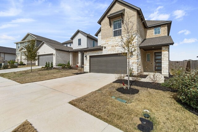 traditional-style home with an attached garage, a shingled roof, fence, stone siding, and driveway