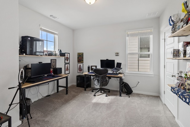 carpeted home office featuring visible vents and baseboards