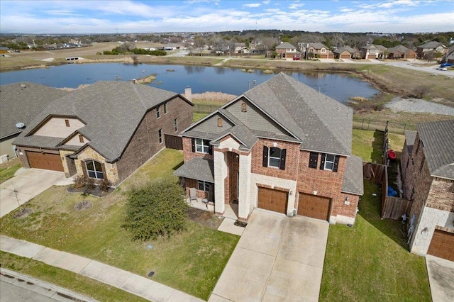 bird's eye view featuring a water view and a residential view