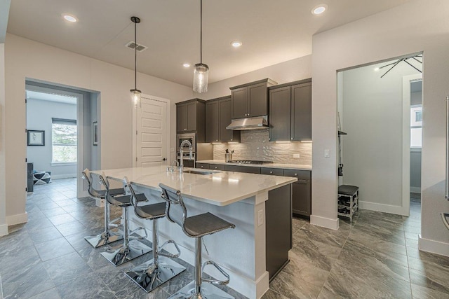 253 Sweeping Sage Ln, San Marcos, TX 78666 - kitchen with a sink, stainless steel gas stovetop, baseboards, backsplash, and recessed lighting