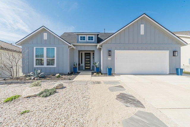 view of front of property with a garage, roof with shingles, board and batten siding, and concrete driveway