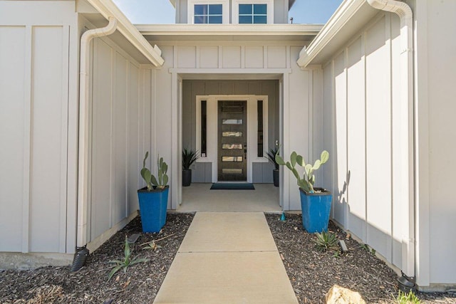 view of exterior entry featuring board and batten siding