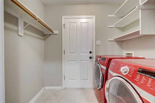 laundry room featuring laundry area, independent washer and dryer, and baseboards