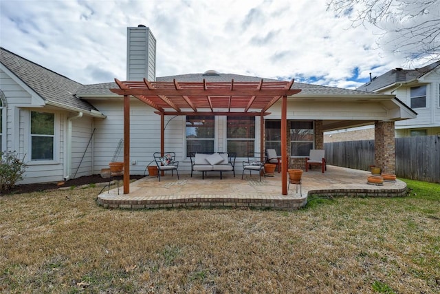 back of property featuring fence, a lawn, a chimney, a patio area, and a pergola