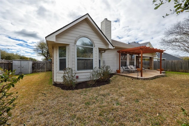 rear view of property with a patio, a yard, a fenced backyard, a pergola, and a chimney