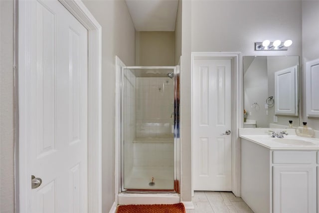 full bathroom with vanity, a shower stall, and tile patterned flooring